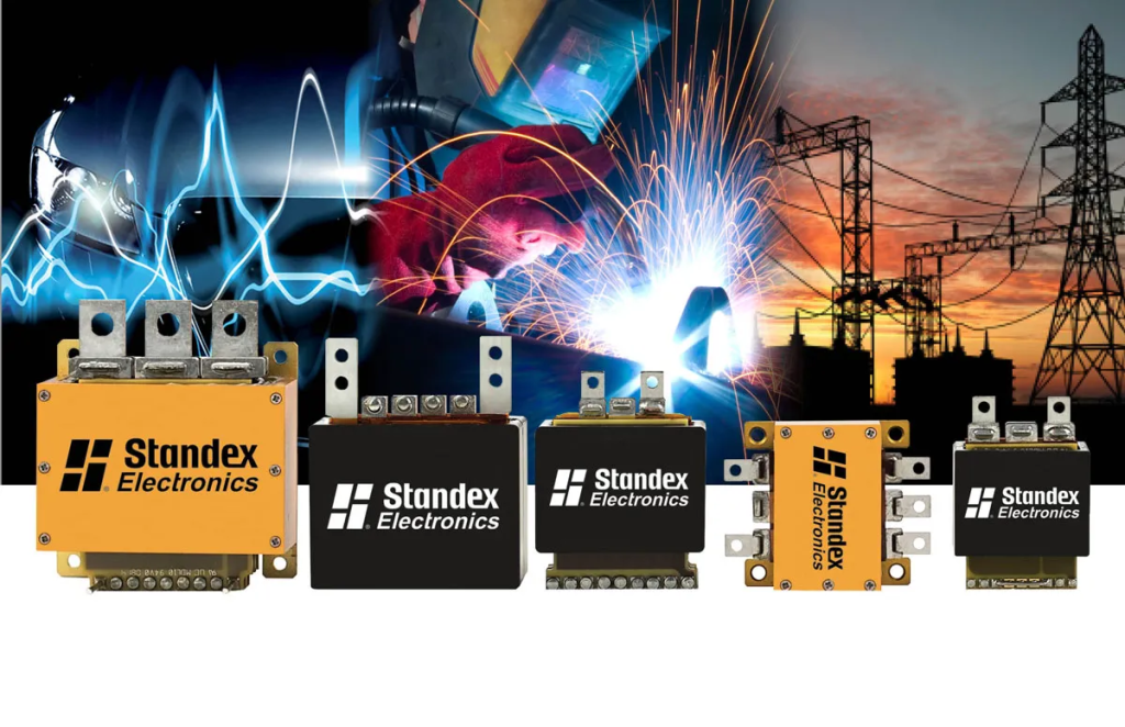 Five Standex Electronics relays are displayed in front of a backdrop featuring welding, electrical sparks, and power lines, highlighting their role in industrial and electrical applications such as power magnetics and planar transformer solutions. by Standex Edge