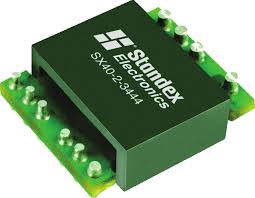 A green Standex Edge SX40-2-3444 power inductor is shown, featuring metal pins on both sides for easy mounting on a circuit board. by Standex Edge