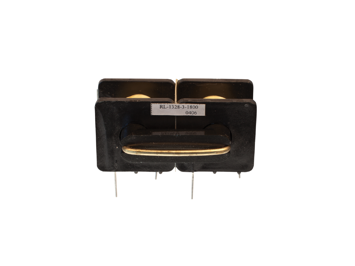 A close-up of a black power inductor with gold-colored accents, four metal pins at the bottom, and a label reading RL-1328-3-1800 0406 on the front, showcasing advanced power magnetics from Standex Edge. by Standex Edge