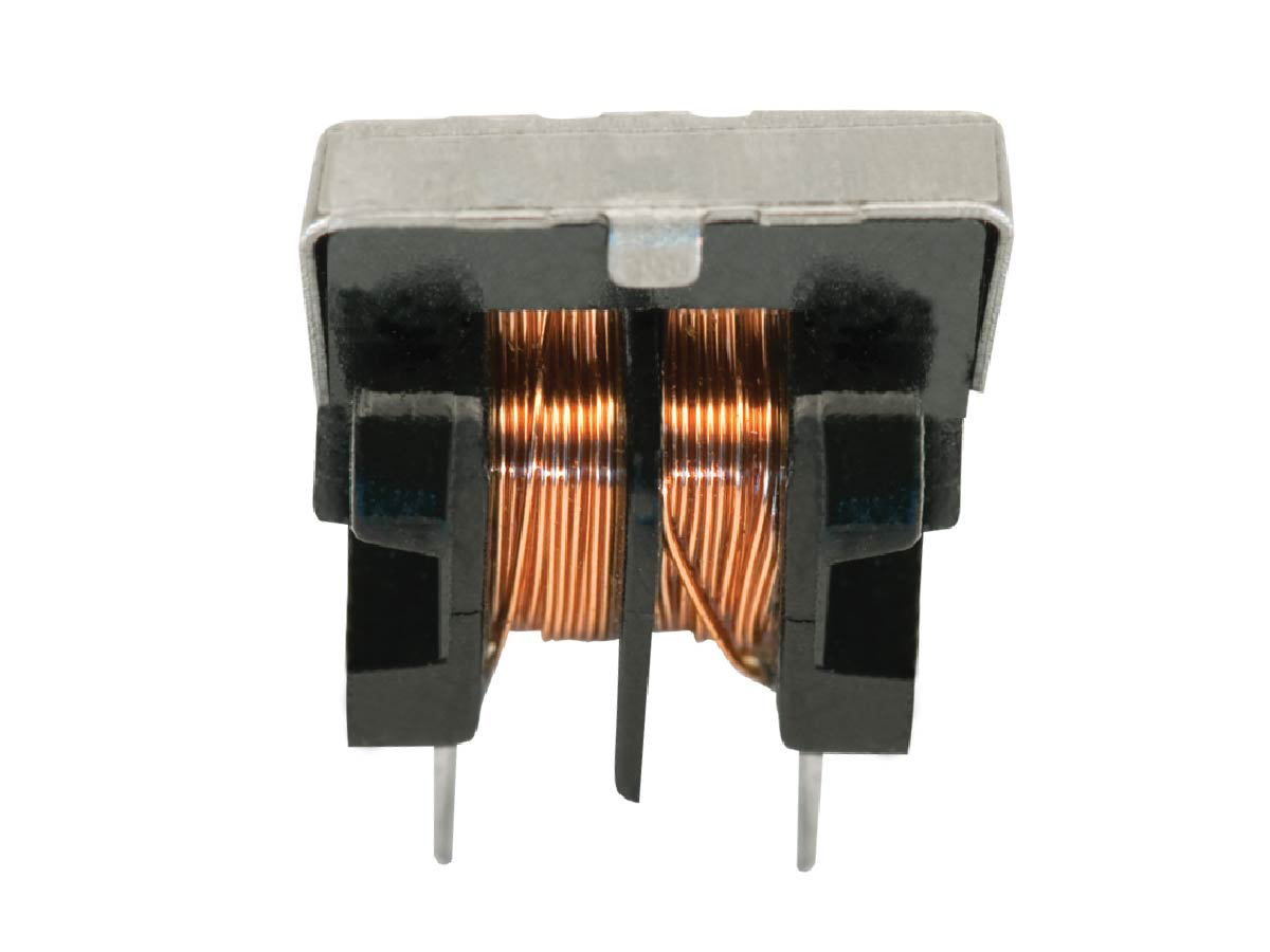 A close-up view of an electronic component with copper wire coils and two metal pins, typically used as a Standex Edge high frequency transformer or power inductor in electronic circuits. by Standex Edge