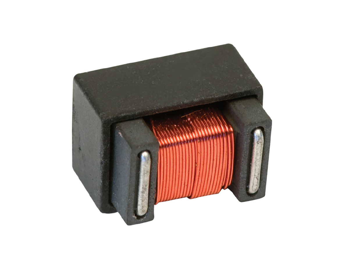 A close-up of a power inductor, featuring a rectangular black casing with a coil of copper wire wound around its center, highlights its use in high frequency transformer applications. by Standex Edge