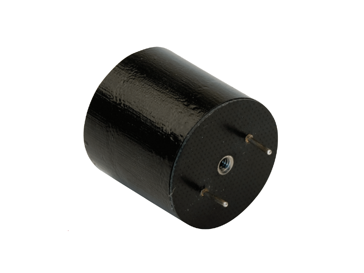 A black cylindrical electronic component with two metal pins protruding from one end, resembling a high frequency transformer, isolated on a white background. by Standex Edge